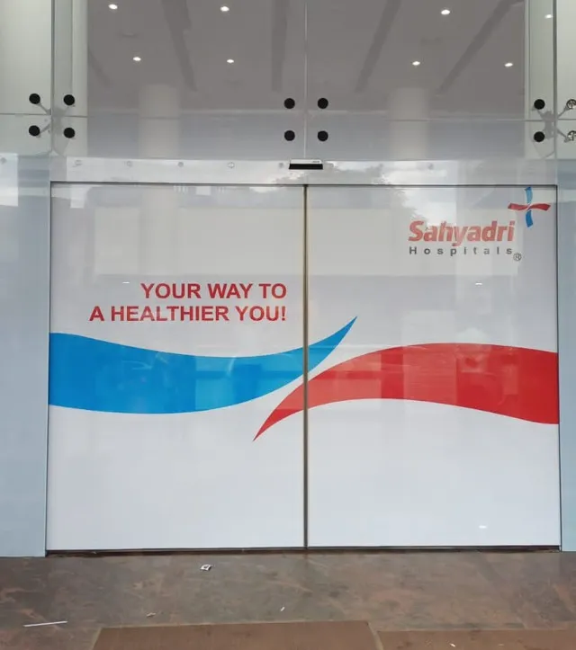 Sahyadri Hospitals glass entrance doors with a printed brand film