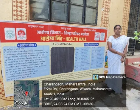 Painted community health information wall with a person standing beside it